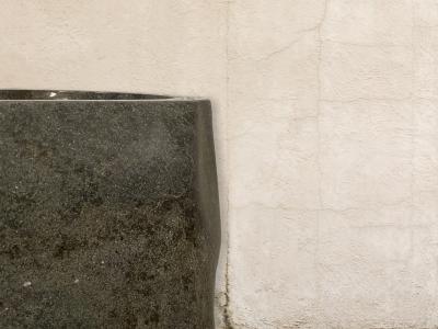 DETAIL OF FREESTANDING SINK IN POLISHED STONE