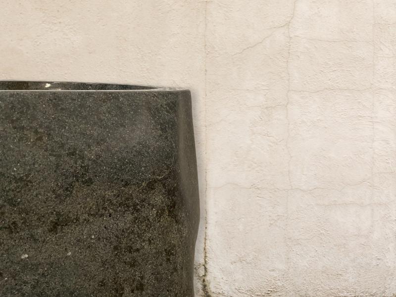 DETAIL OF FREESTANDING SINK IN POLISHED STONE